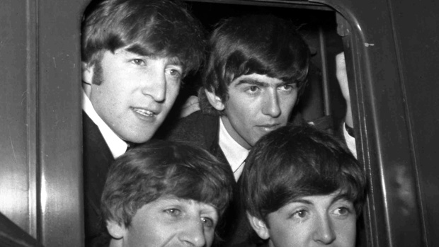 The Beatles, clockwise from top left, John Lennon, George Harrison, Paul McCartney and Ringo Starr, at Paddington Station in London, March 2, 1964. Photo / AP